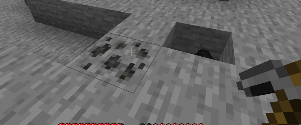 An image showing how coal looks in minecraft java edition