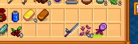 A screenshot from Stardew Valley showing bait and a fishing rod and a hook in the player's inventory